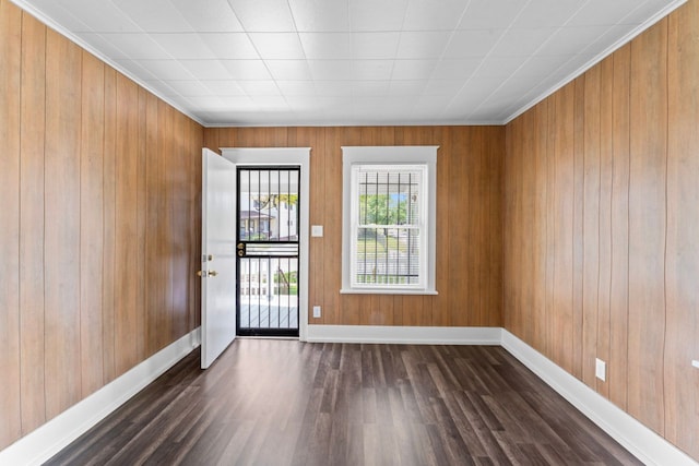 203 E Stewart Ave, Flint, MI 48505 - unfurnished room featuring dark wood-style floors, baseboards, and wood walls