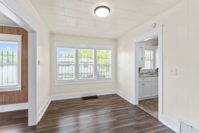203 E Stewart Ave, Flint, MI 48505 - spare room with crown molding, plenty of natural light, dark wood-style floors, and a sink