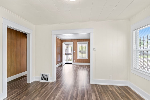 203 E Stewart Ave, Flint, MI 48505 - spare room with dark wood-type flooring, baseboards, and ornamental molding