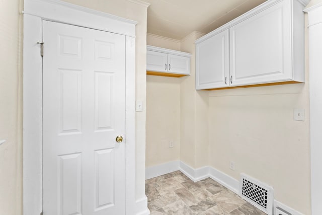 203 E Stewart Ave, Flint, MI 48505 - laundry area with baseboards, ornamental molding, and stone finish flooring