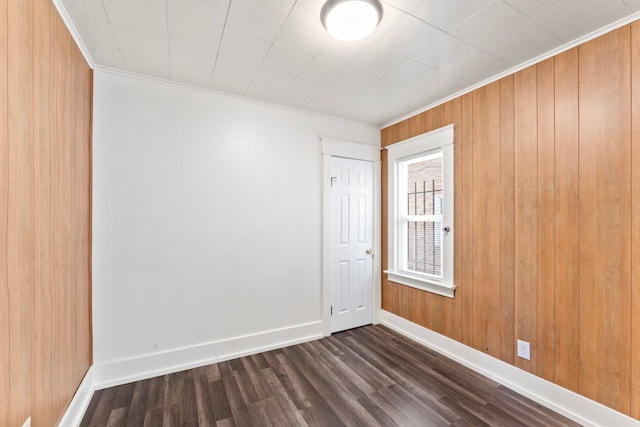 203 E Stewart Ave, Flint, MI 48505 - spare room featuring dark wood-style floors, crown molding, baseboards, and wooden walls