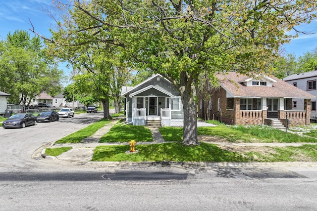 203 E Stewart Ave, Flint, MI 48505 - view of front of home with covered porch and brick siding