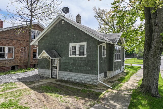 203 E Stewart Ave, Flint, MI 48505 - back of house featuring a chimney