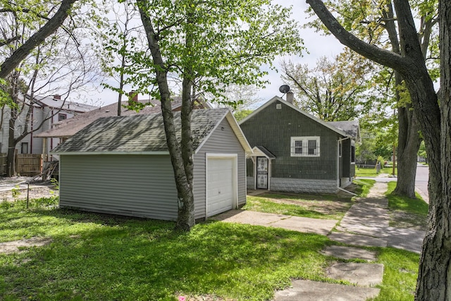 203 E Stewart Ave, Flint, MI 48505 - view of side of home featuring driveway, a garage, and roof with shingles