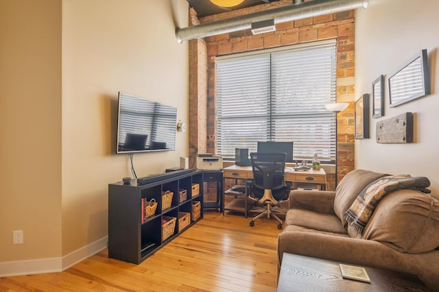 office area featuring baseboards and wood-type flooring