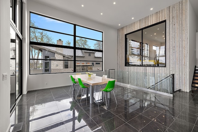 dining area featuring baseboards, recessed lighting, wallpapered walls, and granite tiled floors