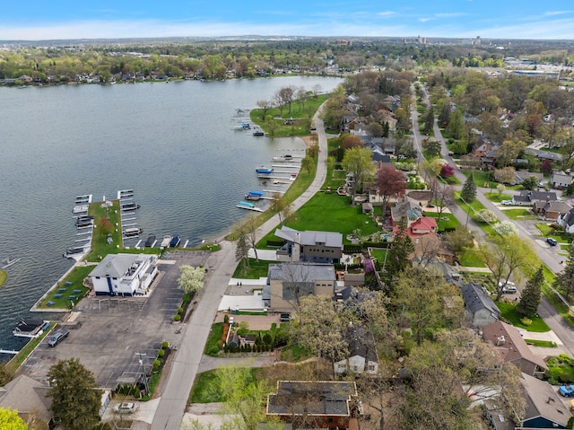 aerial view of property's location featuring a nearby body of water and nearby suburban area