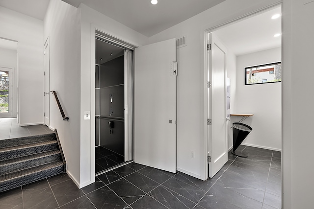 stairway with healthy amount of natural light, baseboards, and recessed lighting