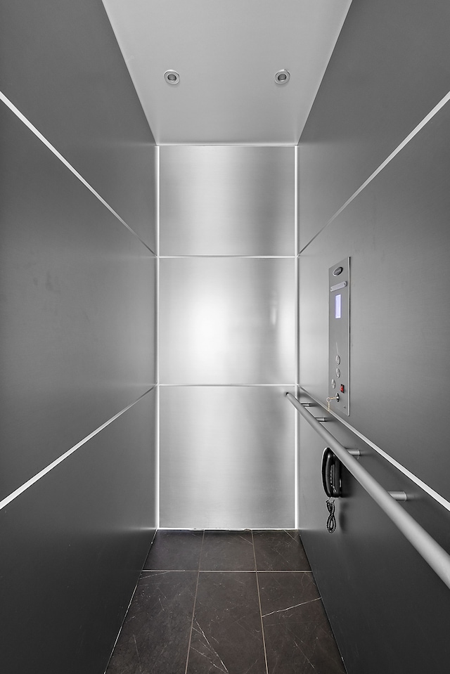 bathroom featuring elevator, tile patterned floors, and recessed lighting