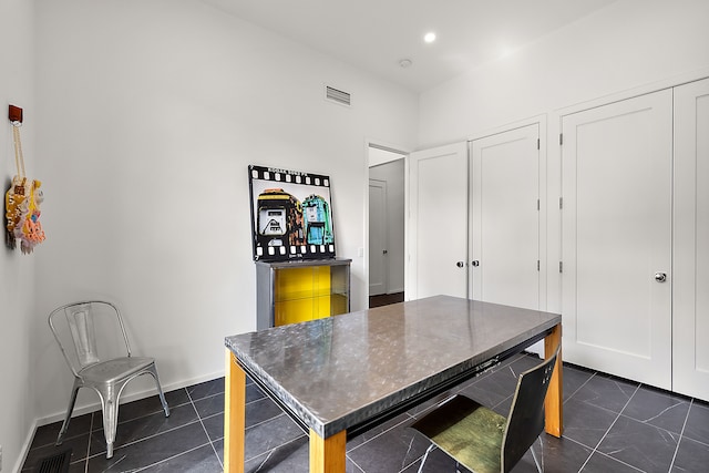 dining room featuring dark tile patterned flooring, recessed lighting, and baseboards