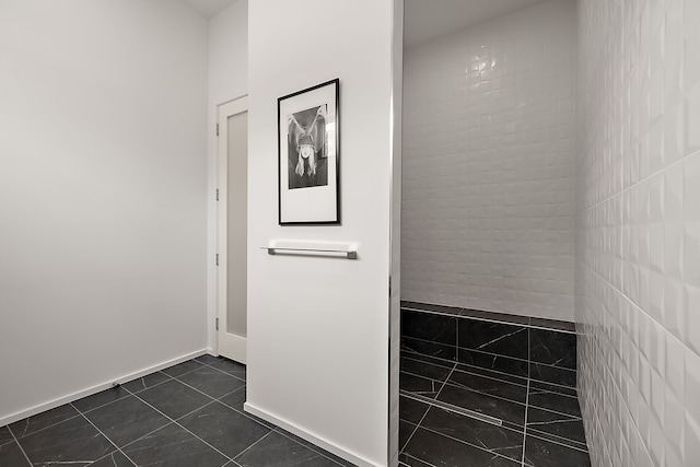 corridor with dark tile patterned flooring