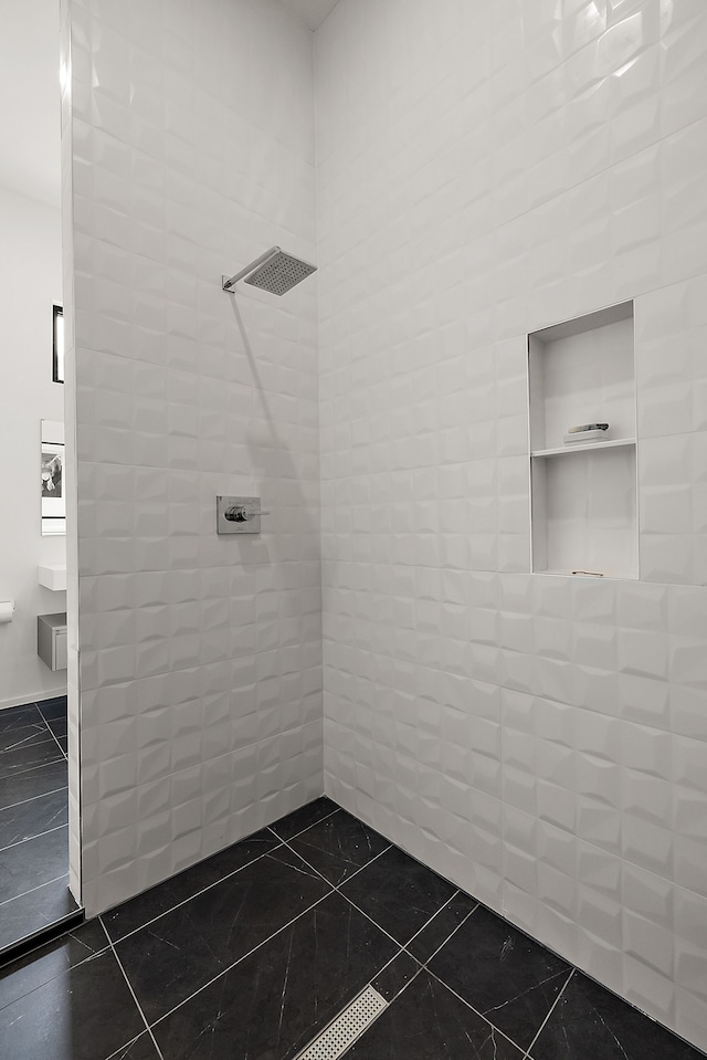 bathroom with tiled shower, tile walls, and tile patterned flooring