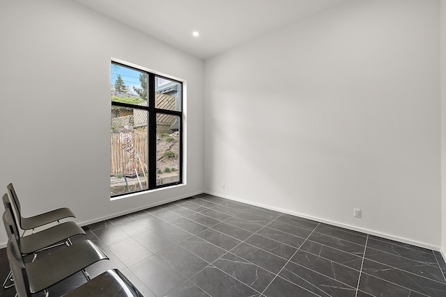 empty room featuring baseboards and recessed lighting