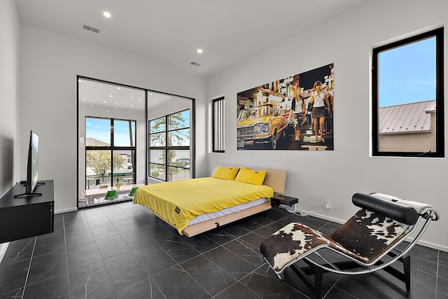 bedroom featuring recessed lighting, baseboards, and dark tile patterned floors
