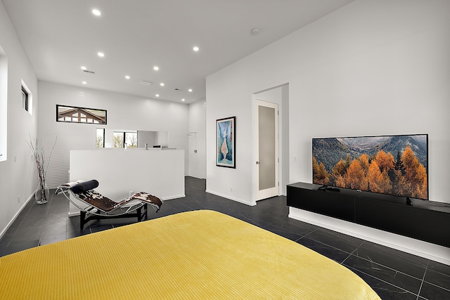 bedroom featuring recessed lighting, dark tile patterned flooring, and baseboards