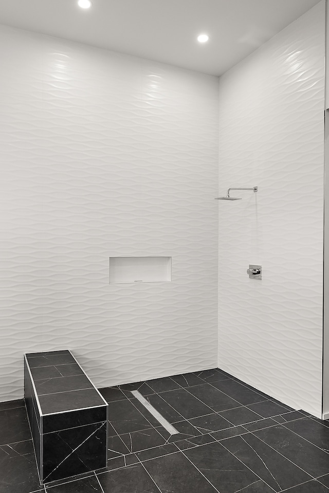 bathroom with tile walls, recessed lighting, and tiled shower