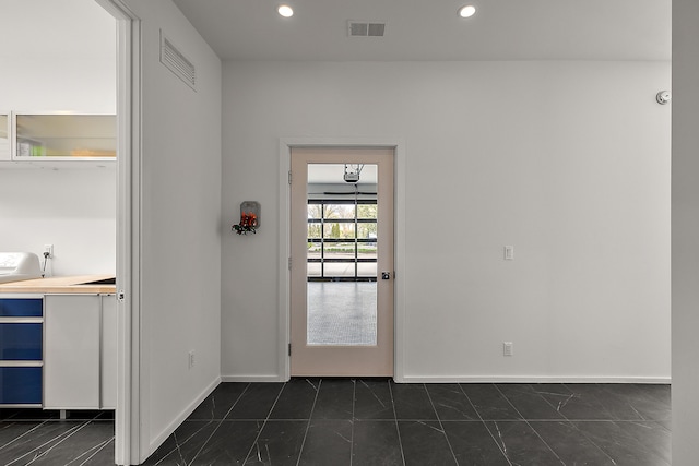 doorway with recessed lighting and baseboards