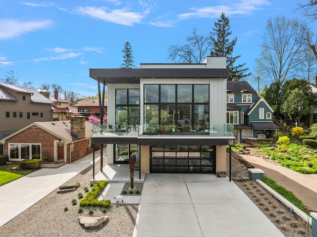 2331 Ferndale Ave, Sylvan Lake, MI 48320 - modern home featuring a garage, driveway, and a residential view