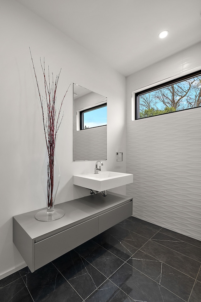 2331 Ferndale Ave, Sylvan Lake, MI 48320 - bathroom with marble look tile flooring and recessed lighting