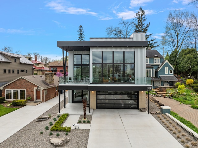 2331 Ferndale Ave, Sylvan Lake, MI 48320 - contemporary house featuring a garage, concrete driveway, and a residential view