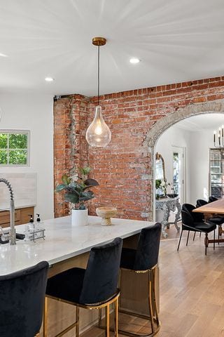 2423 Chicago Blvd, Detroit, MI 48206 - dining space with recessed lighting, arched walkways, light wood-style floors, and brick wall