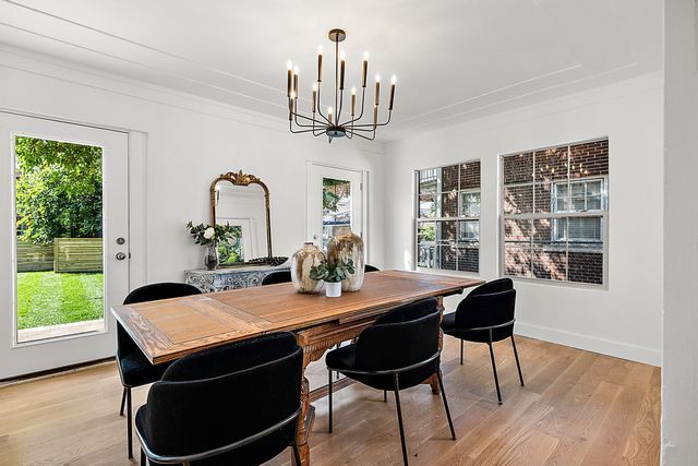 2423 Chicago Blvd, Detroit, MI 48206 - dining room featuring light wood-style flooring, a notable chandelier, and crown molding