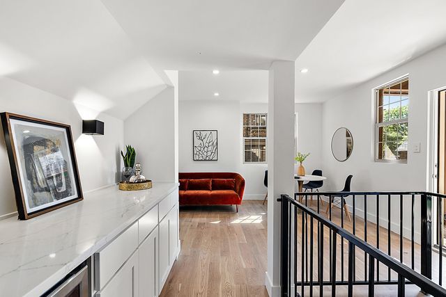 2423 Chicago Blvd, Detroit, MI 48206 - corridor featuring recessed lighting, wine cooler, an upstairs landing, light wood-type flooring, and baseboards