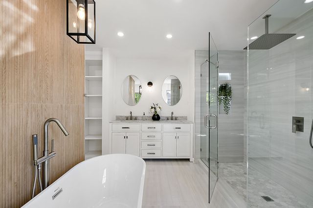 2423 Chicago Blvd, Detroit, MI 48206 - full bath with a freestanding bath, double vanity, a stall shower, and a sink