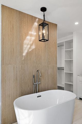 2423 Chicago Blvd, Detroit, MI 48206 - full bathroom with a soaking tub, recessed lighting, and wood finished floors
