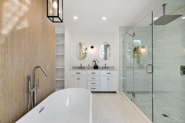 2423 Chicago Blvd, Detroit, MI 48206 - full bath with a soaking tub, a shower stall, double vanity, and a sink