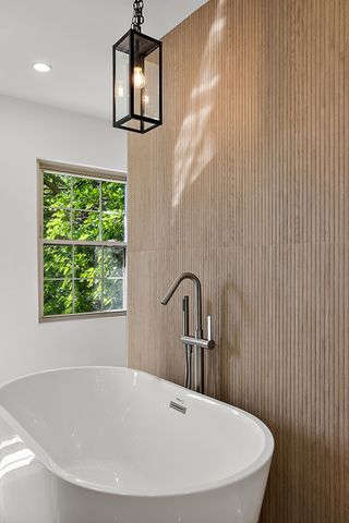2423 Chicago Blvd, Detroit, MI 48206 - full bathroom featuring a freestanding tub and a sink