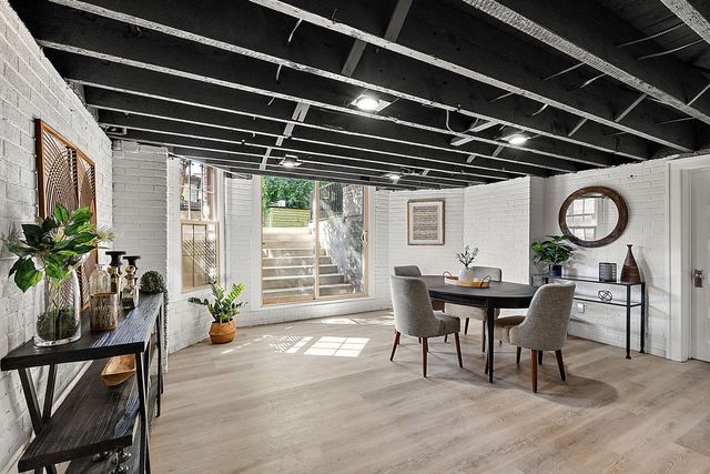 2423 Chicago Blvd, Detroit, MI 48206 - dining room with wood finished floors and brick wall