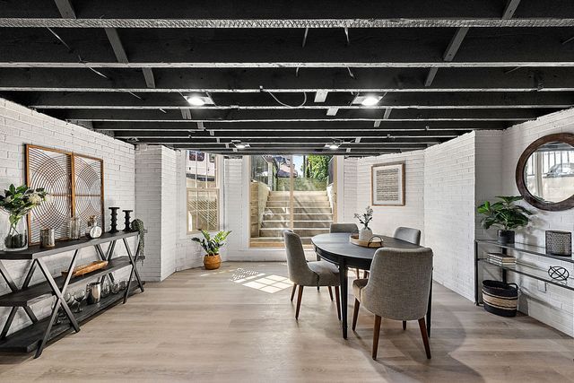 2423 Chicago Blvd, Detroit, MI 48206 - interior space featuring wood finished floors and brick wall