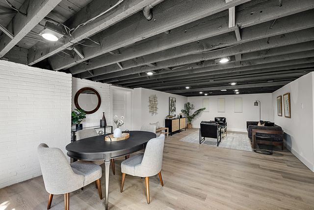 2423 Chicago Blvd, Detroit, MI 48206 - dining area featuring wood finished floors and brick wall