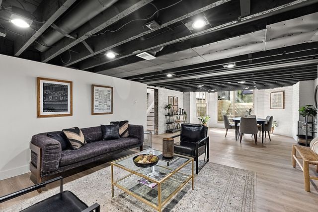 2423 Chicago Blvd, Detroit, MI 48206 - living area with visible vents, stairway, and wood finished floors