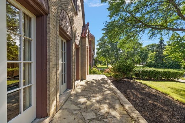 2423 Chicago Blvd, Detroit, MI 48206 - view of home's exterior featuring a patio and brick siding