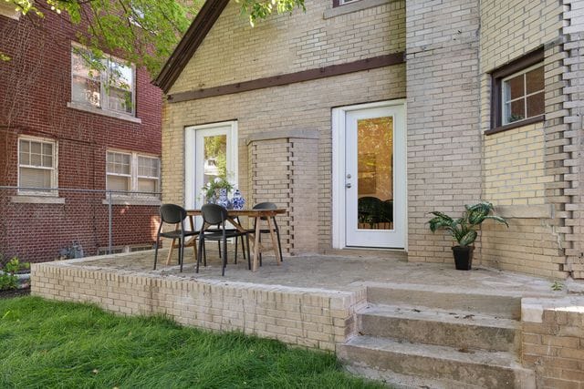 2423 Chicago Blvd, Detroit, MI 48206 - doorway to property featuring brick siding and a patio area