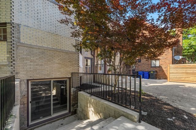 2423 Chicago Blvd, Detroit, MI 48206 - exterior space featuring fence and brick siding