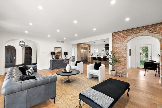 2423 Chicago Blvd, Detroit, MI 48206 - living room featuring visible vents, arched walkways, light wood finished floors, and recessed lighting