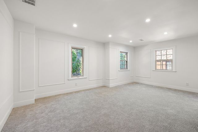 2423 Chicago Blvd, Detroit, MI 48206 - empty room with light colored carpet, visible vents, and a healthy amount of sunlight