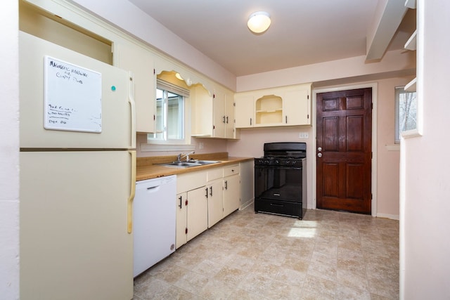 kitchen featuring white appliances, open shelves, a sink, and light countertops
