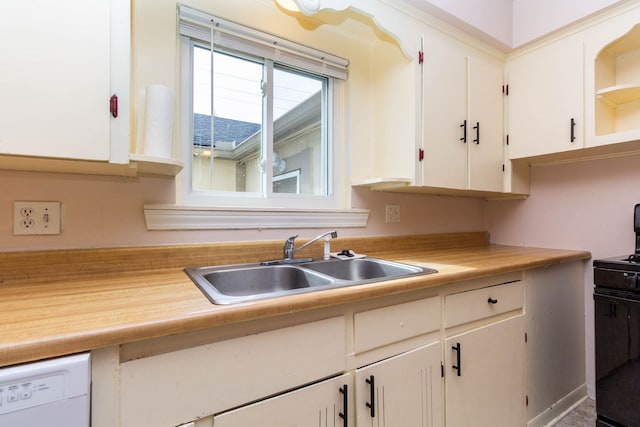 kitchen featuring black gas stove, light countertops, white cabinets, a sink, and dishwasher