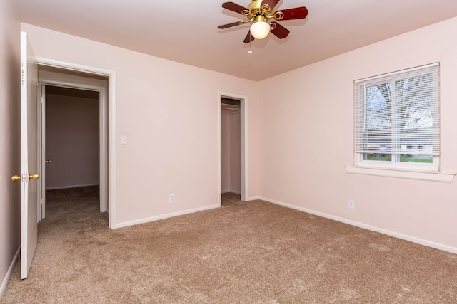 unfurnished bedroom with baseboards, light colored carpet, and a closet