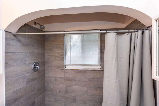 full bathroom with tiled shower