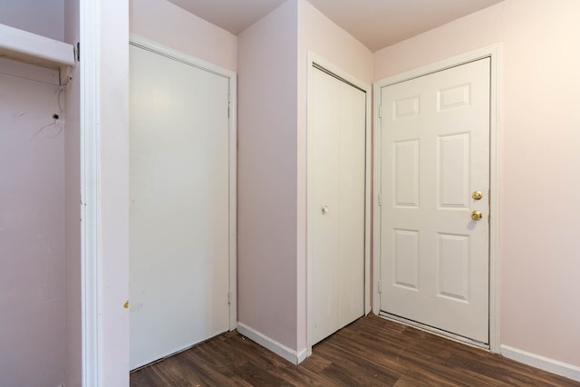 entryway with dark wood-style flooring and baseboards