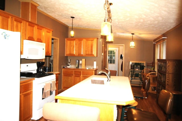 kitchen featuring white appliances, brown cabinetry, light countertops, ornamental molding, and dark wood-style floors