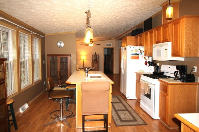kitchen with white appliances, light countertops, a ceiling fan, and a sink