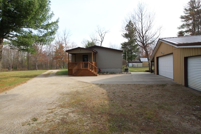 exterior space with a garage, an outbuilding, and driveway