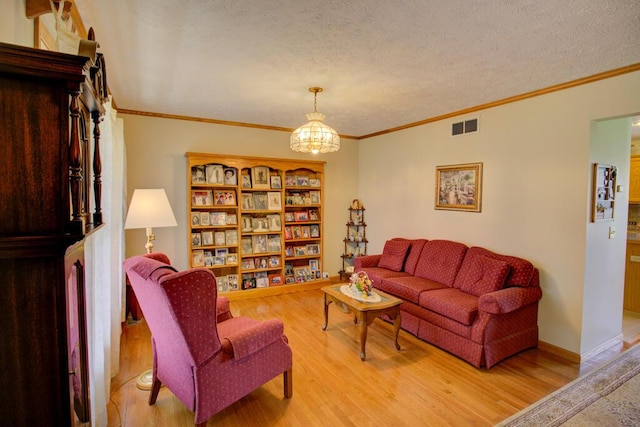 1414 Plains Rd, Leslie, MI 49251 - living room with ornamental molding, a textured ceiling, visible vents, and wood finished floors