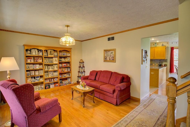 1414 Plains Rd, Leslie, MI 49251 - living area with visible vents, light wood-type flooring, a textured ceiling, and crown molding